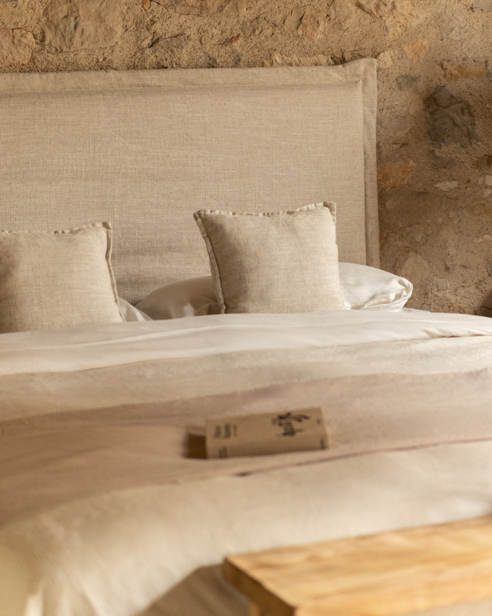 Upholstered headboard with removable beige linen cover in various sizes.