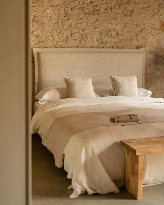 Upholstered headboard with removable beige linen cover in various sizes.