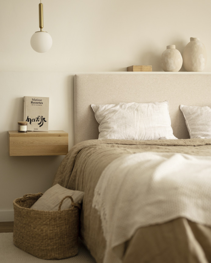 Upholstered headboard in plain beige polyester of various sizes.