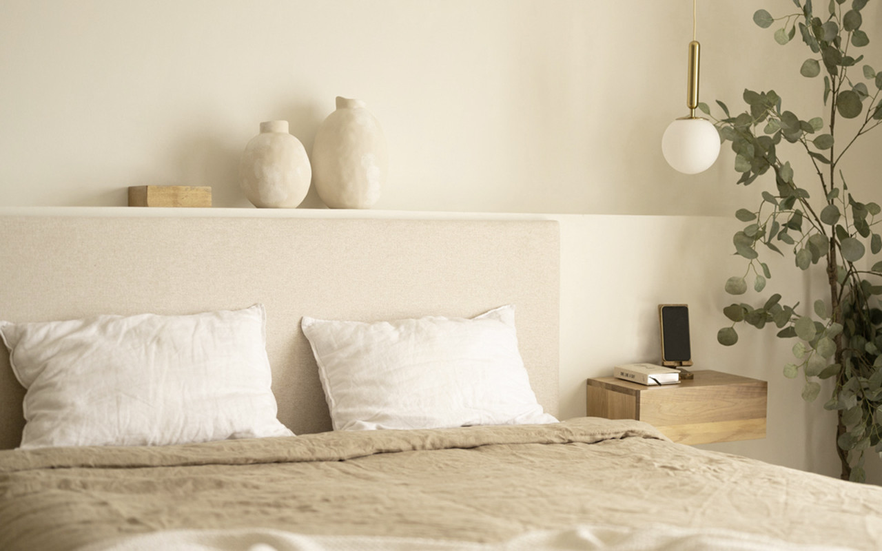 Upholstered headboard in plain beige polyester of various sizes.