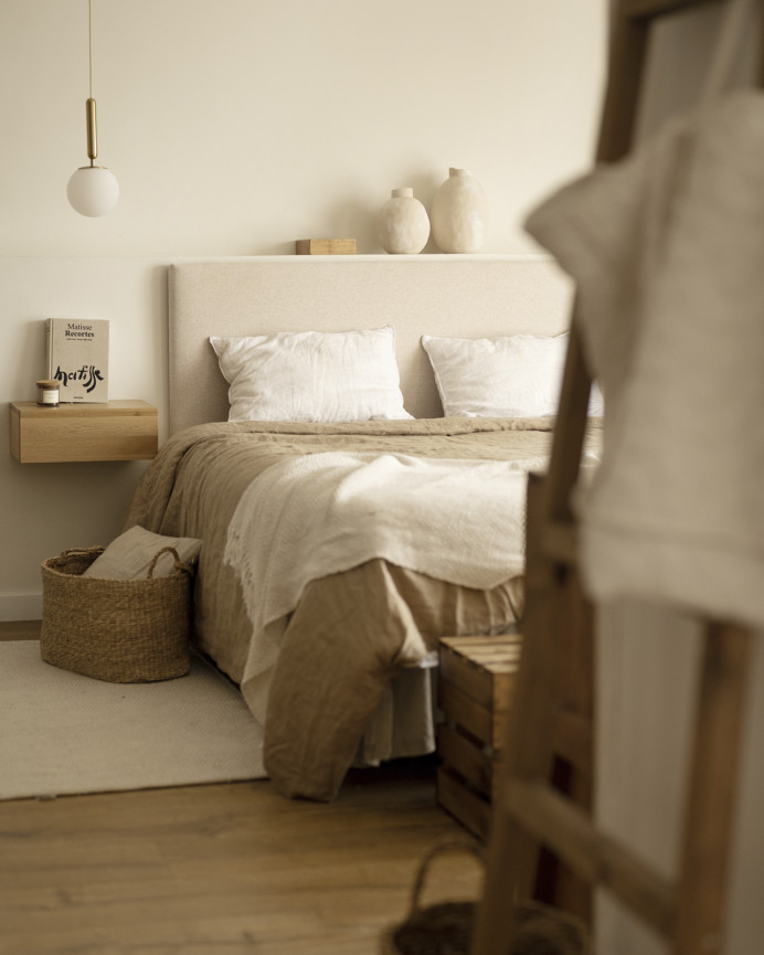Upholstered headboard in plain beige polyester of various sizes.