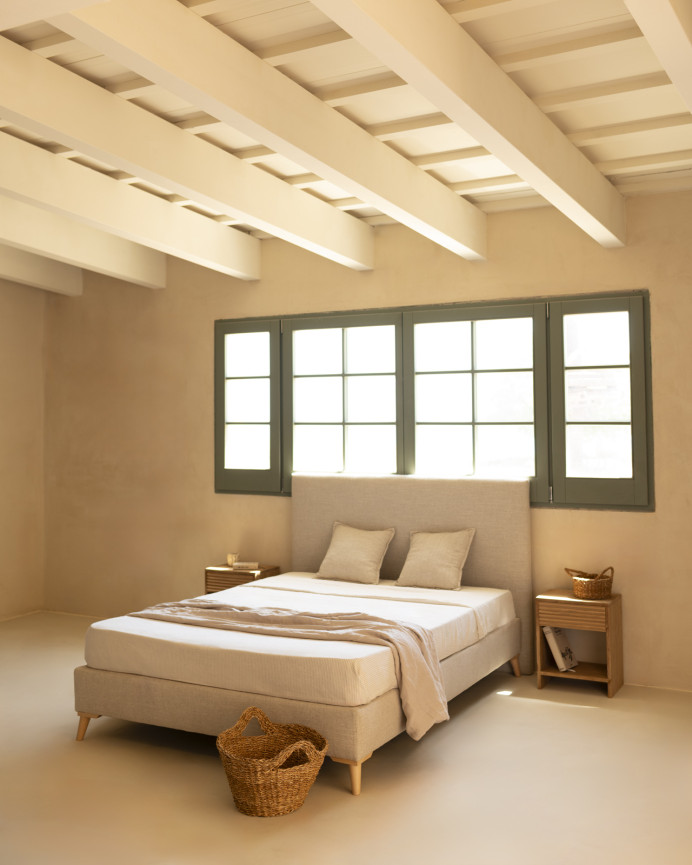 Upholstered beige linen bed frame for mattress of various sizes.