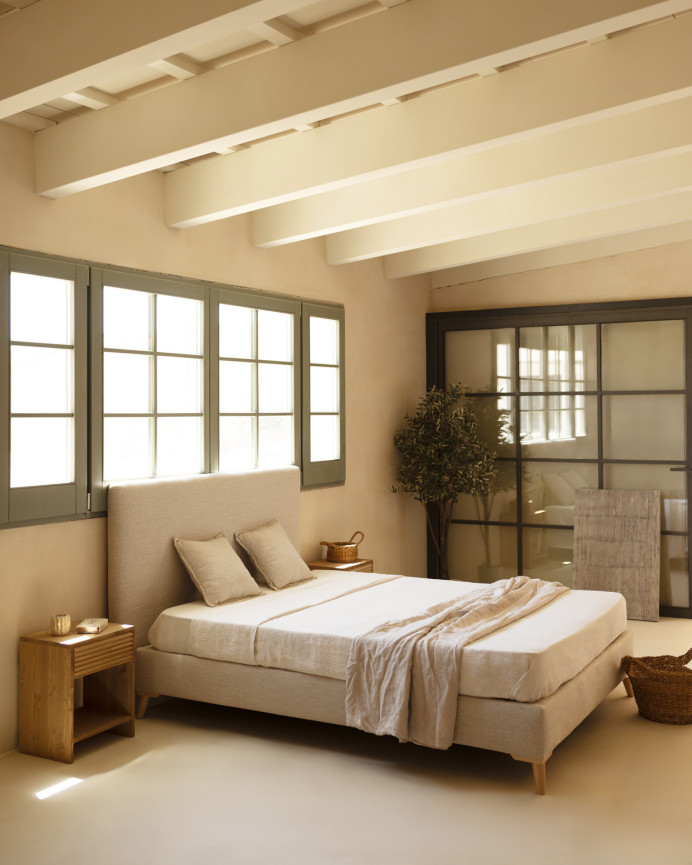 Upholstered beige linen bed frame for mattress of various sizes.