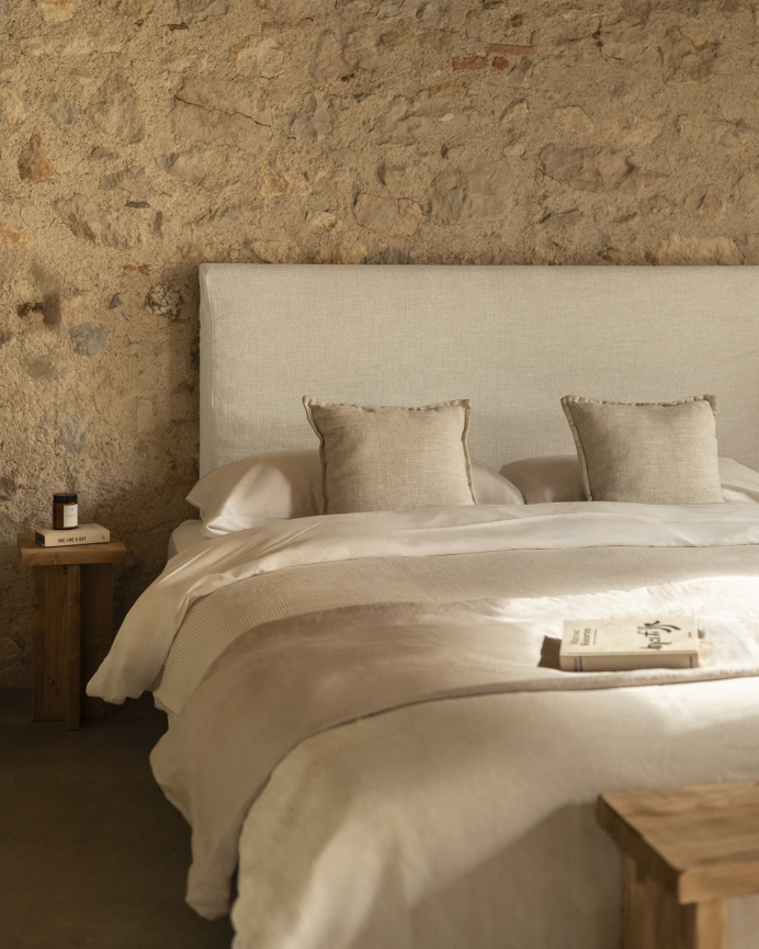Upholstered beige linen headboard with removable cover in various sizes.