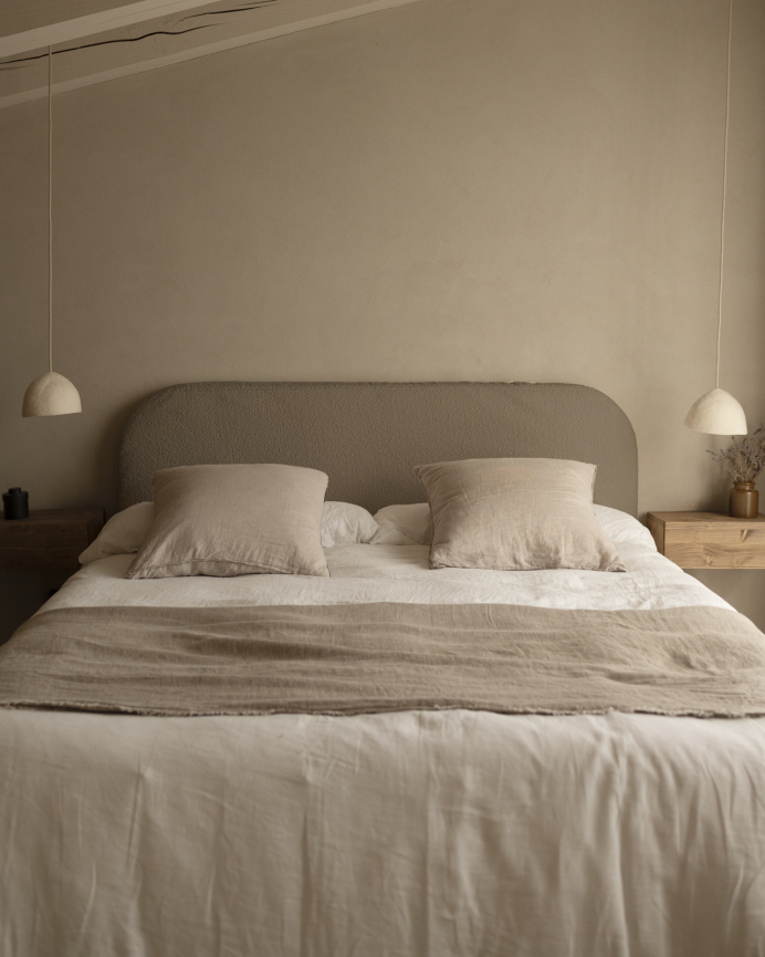 Upholstered headboard in removable brown bouclé fabric in various sizes.