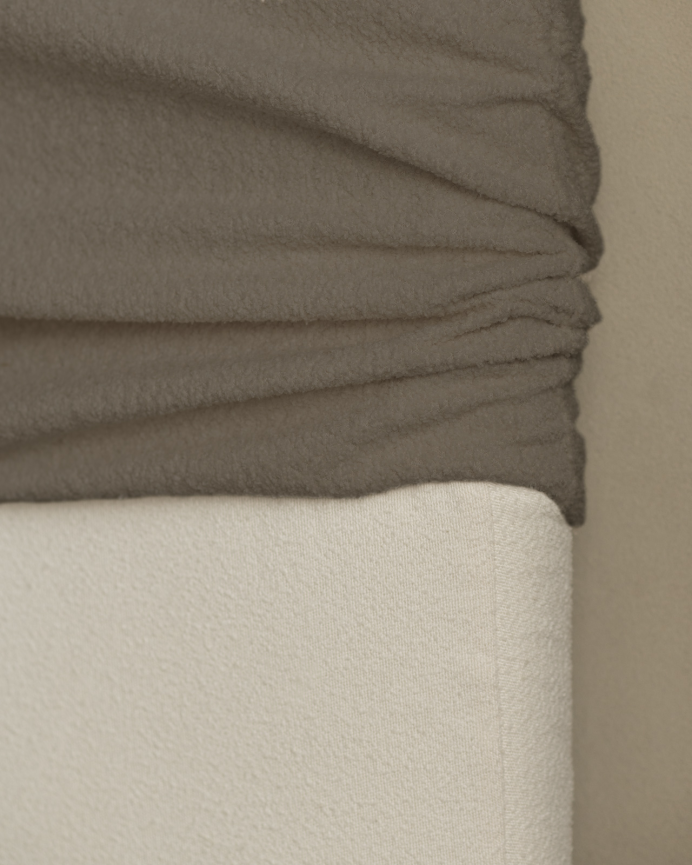 Upholstered headboard in removable brown bouclé fabric in various sizes.