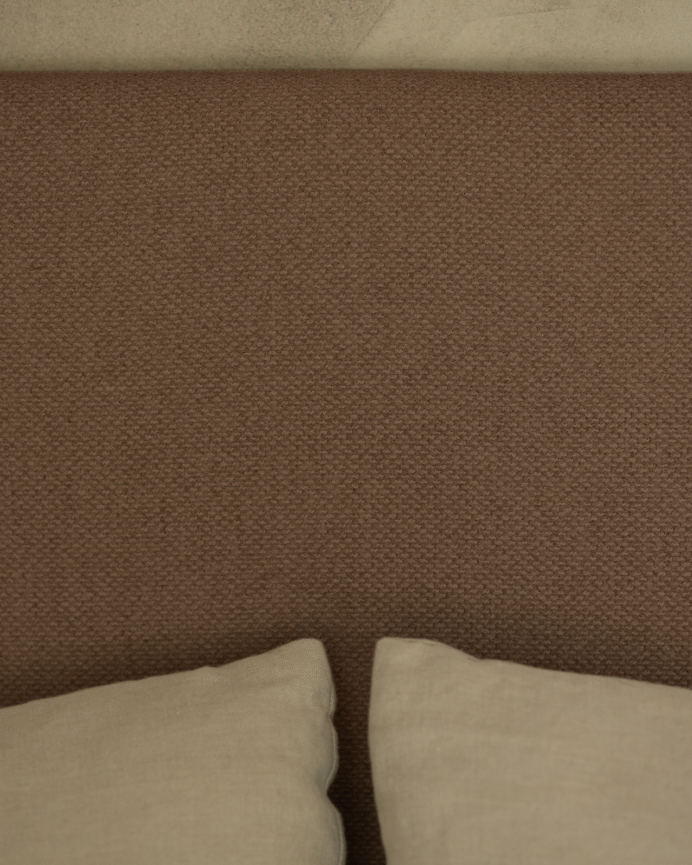 Upholstered headboard in brown color available in various sizes.