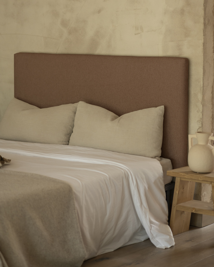 Upholstered headboard in brown color available in various sizes.