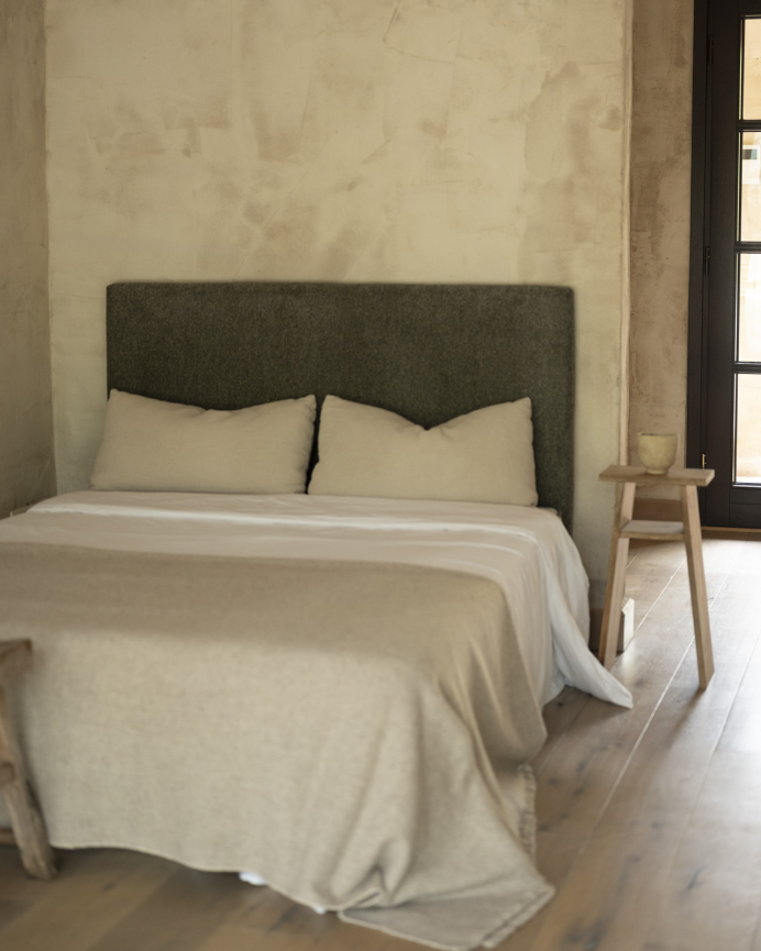 Upholstered headboard in green color, available in various sizes.