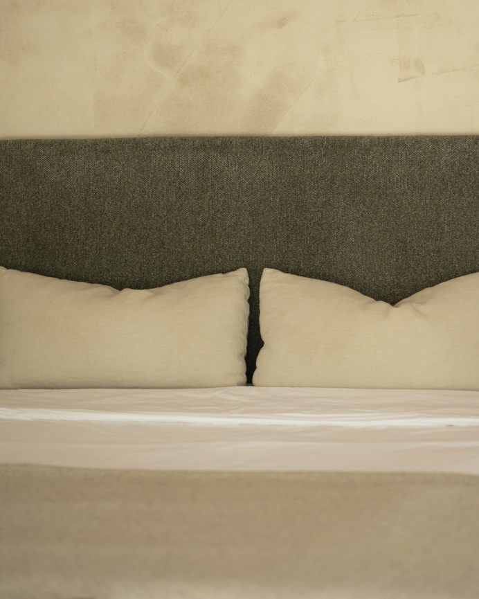 Upholstered headboard in green color, available in various sizes.