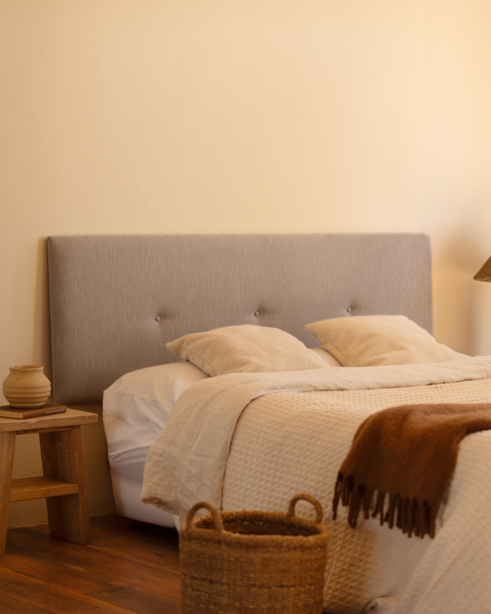 Upholstered polyester headboard with bone-colored buttons in various sizes.