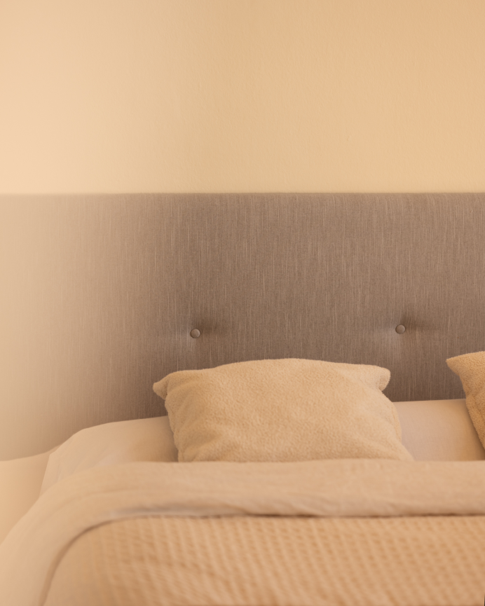Upholstered polyester headboard with bone-colored buttons in various sizes.