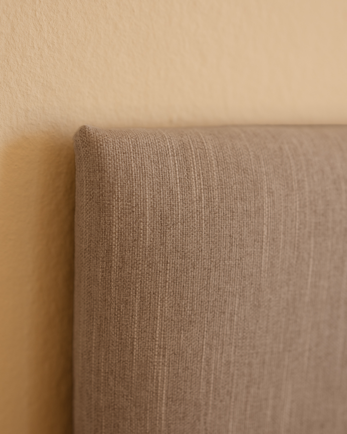 Upholstered polyester headboard with bone-colored buttons in various sizes.