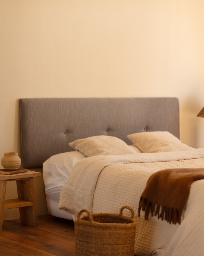 Upholstered polyester headboard with gray buttons in various sizes