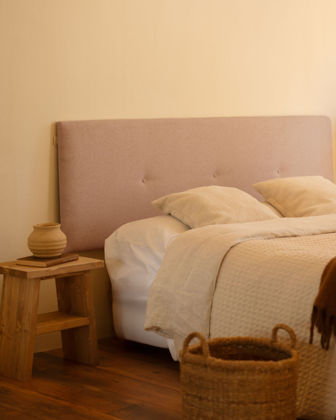 Upholstered polyester headboard with pink buttons available in several sizes.