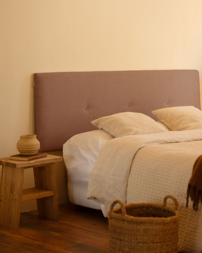 Upholstered polyester headboard with orange buttons in various sizes.