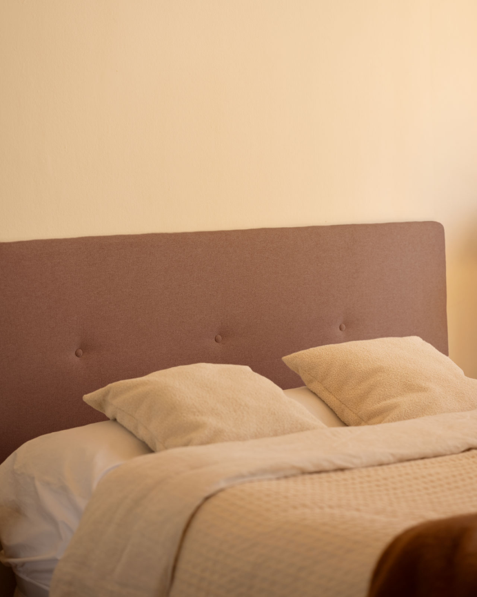 Upholstered polyester headboard with orange buttons in various sizes.