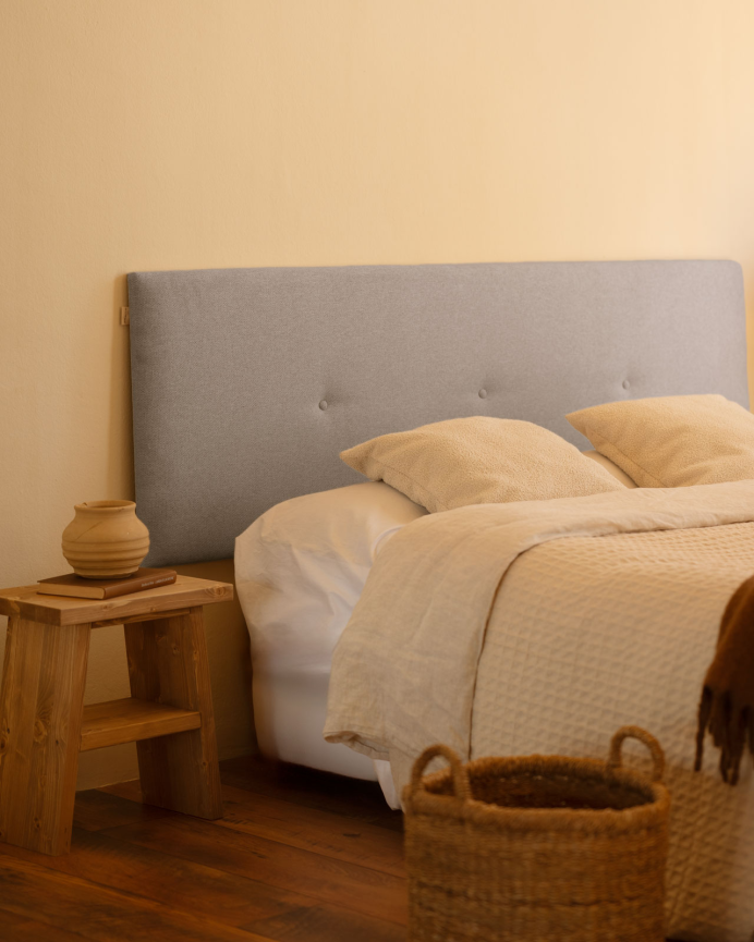 Upholstered polyester headboard with lavender-colored buttons available in various sizes