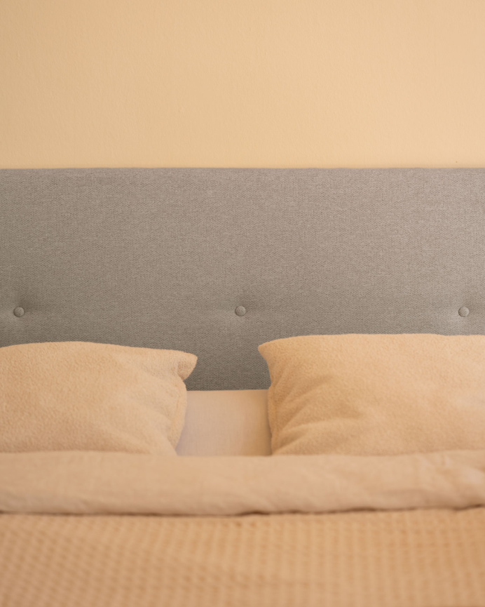 Upholstered polyester headboard with lavender-colored buttons available in various sizes