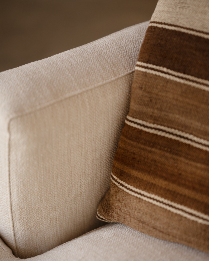 Off-white tone armchair measuring 105x106cm.