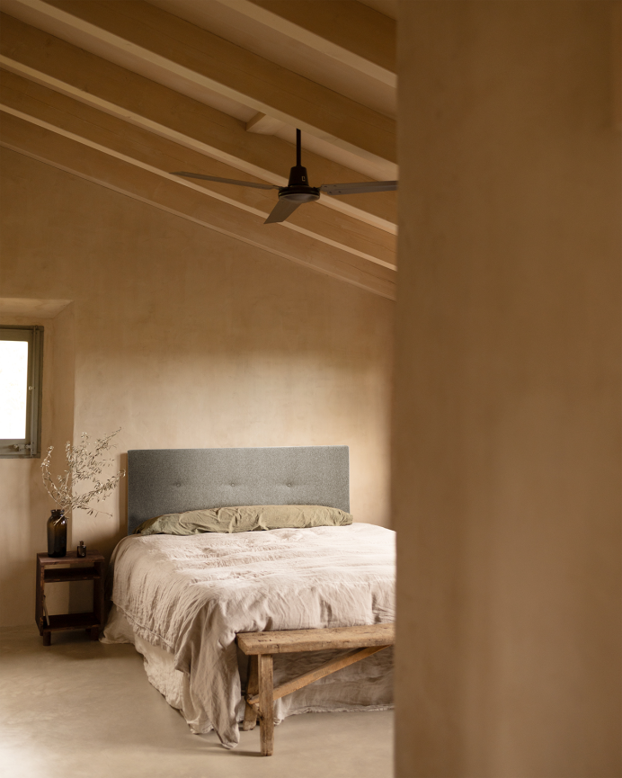 Upholstered polyester headboard with gray buttons in various sizes.