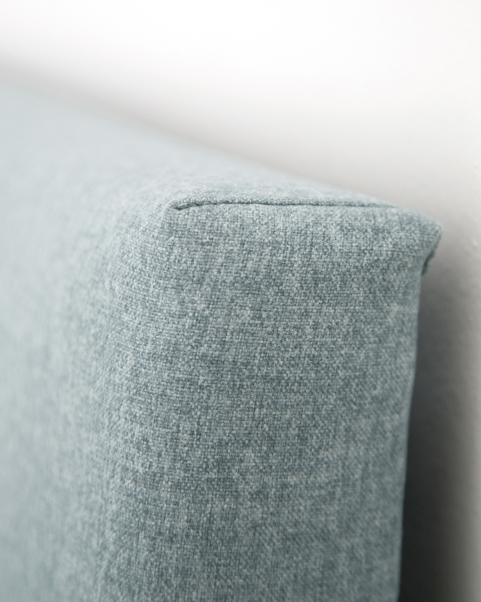 Headboard upholstered in polyester with buttons in teal green in various sizes.