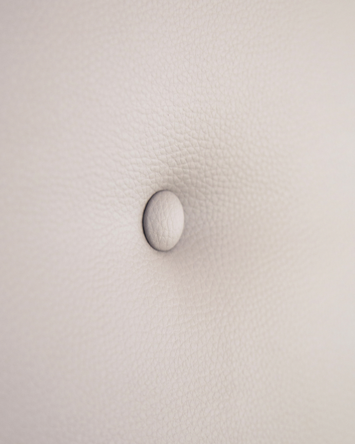 Upholstered headboard in brown faux leather with buttons in various sizes