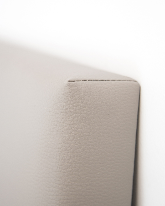 Upholstered headboard in brown faux leather with buttons in various sizes