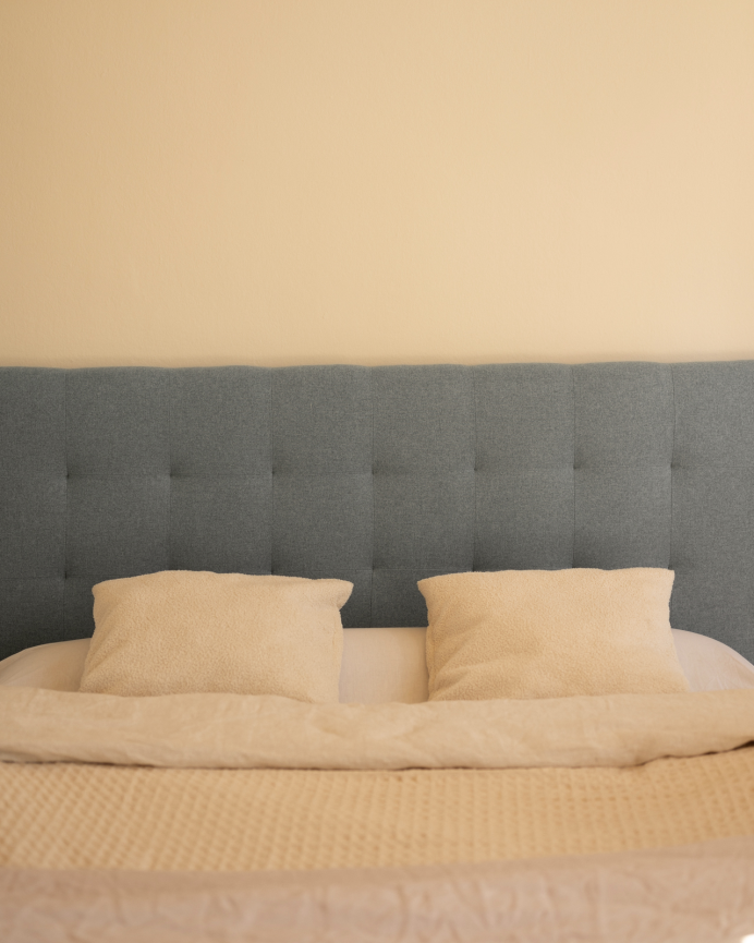 Upholstered polyester headboard with pleats in blue color in various sizes